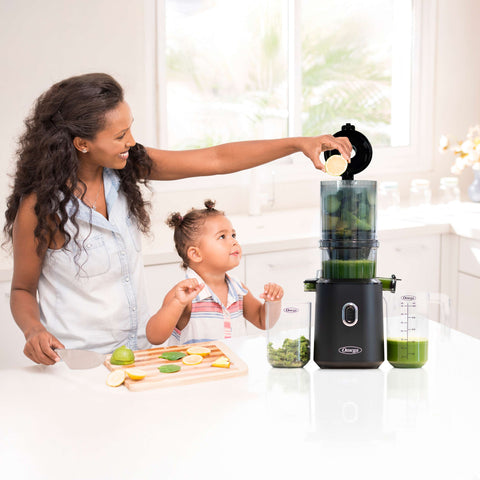 Mom making juice with daughter.