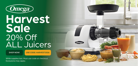 Omega slow juicer in a bright kitchen setting, surrounded by fresh fruits, vegetables, and glasses of juice, with a green promotional banner on the left reading 'Omega Harvest Sale 20% Off All Juicers'.