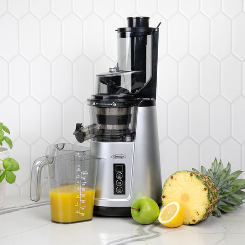 Juicer on counter with fruit and juice